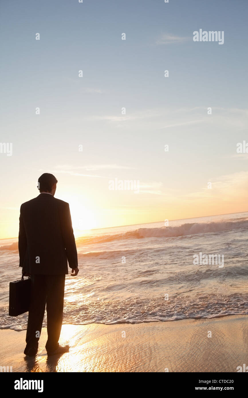 Imprenditore che guarda sul mare Foto Stock