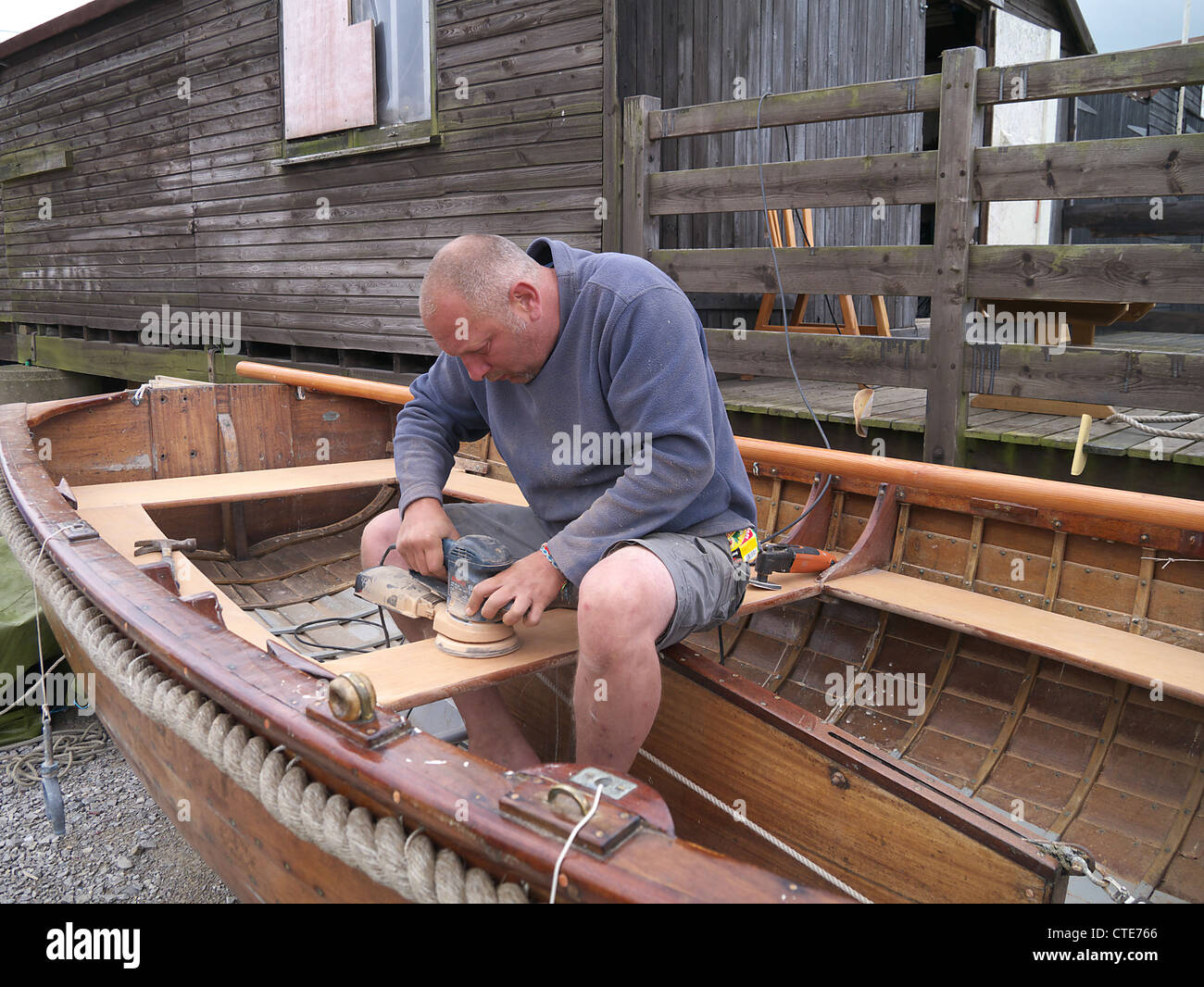 Il costruttore dell'imbarcazione lavorando giù a Southwold Harbour Foto Stock