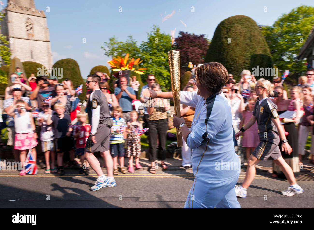 Folla che acclamava Torcia Olimpica bearer, Painswick, Gloucestershire, UK. (23 maggio 2012) Foto Stock