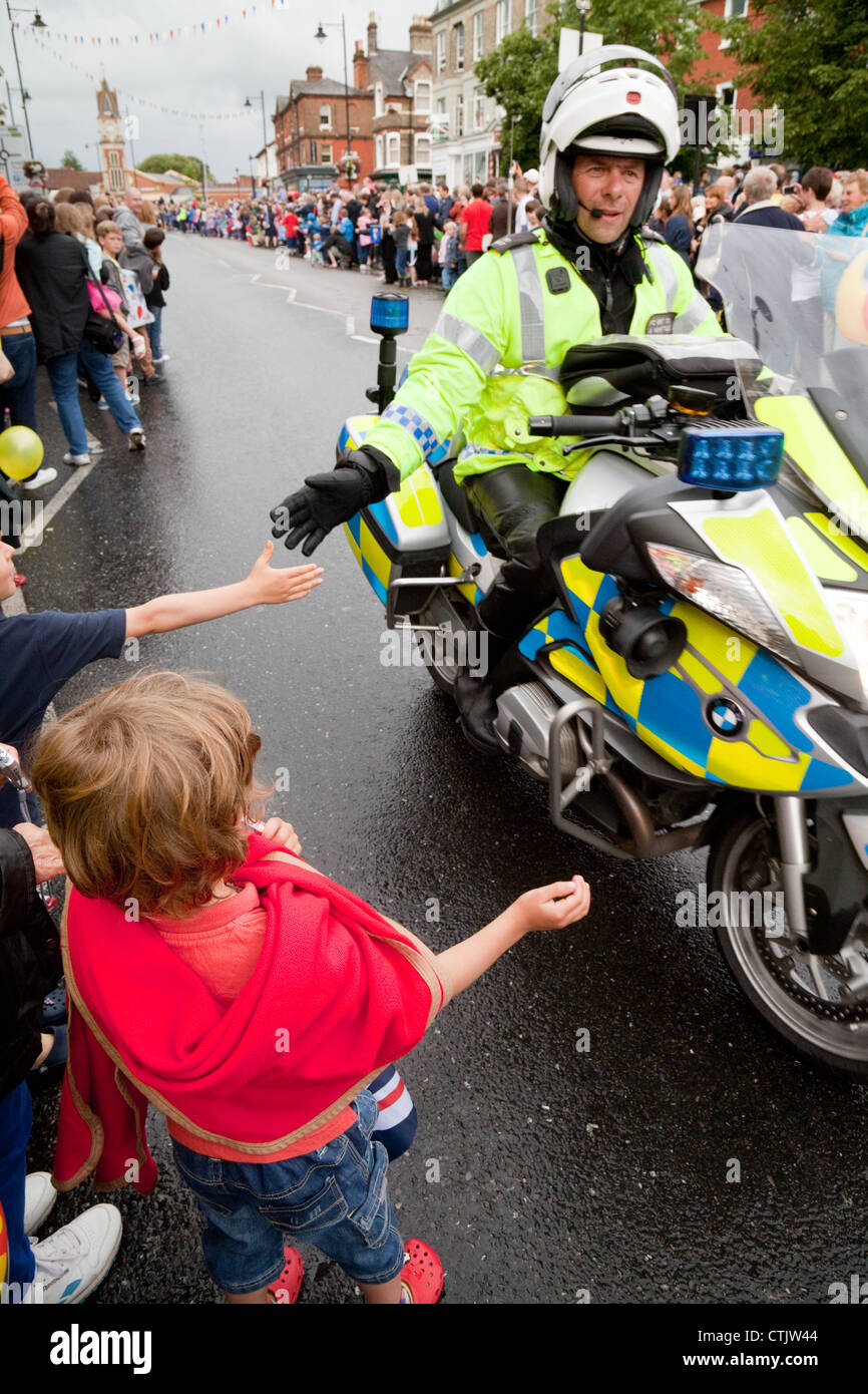Polizia moto patrol dare ai bambini un alto cinque; 2012 torcia olimpica, Newmarket Suffolk REGNO UNITO Foto Stock