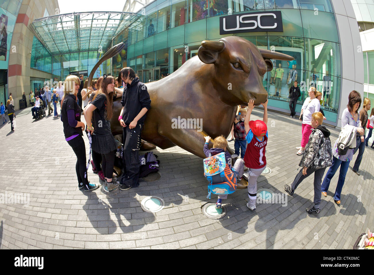 Gli amanti dello shopping e visitatori vicino alla statua di ottone di un toro nella corrida, Birmingham City Centre, West Midlands, England, Regno Unito Foto Stock
