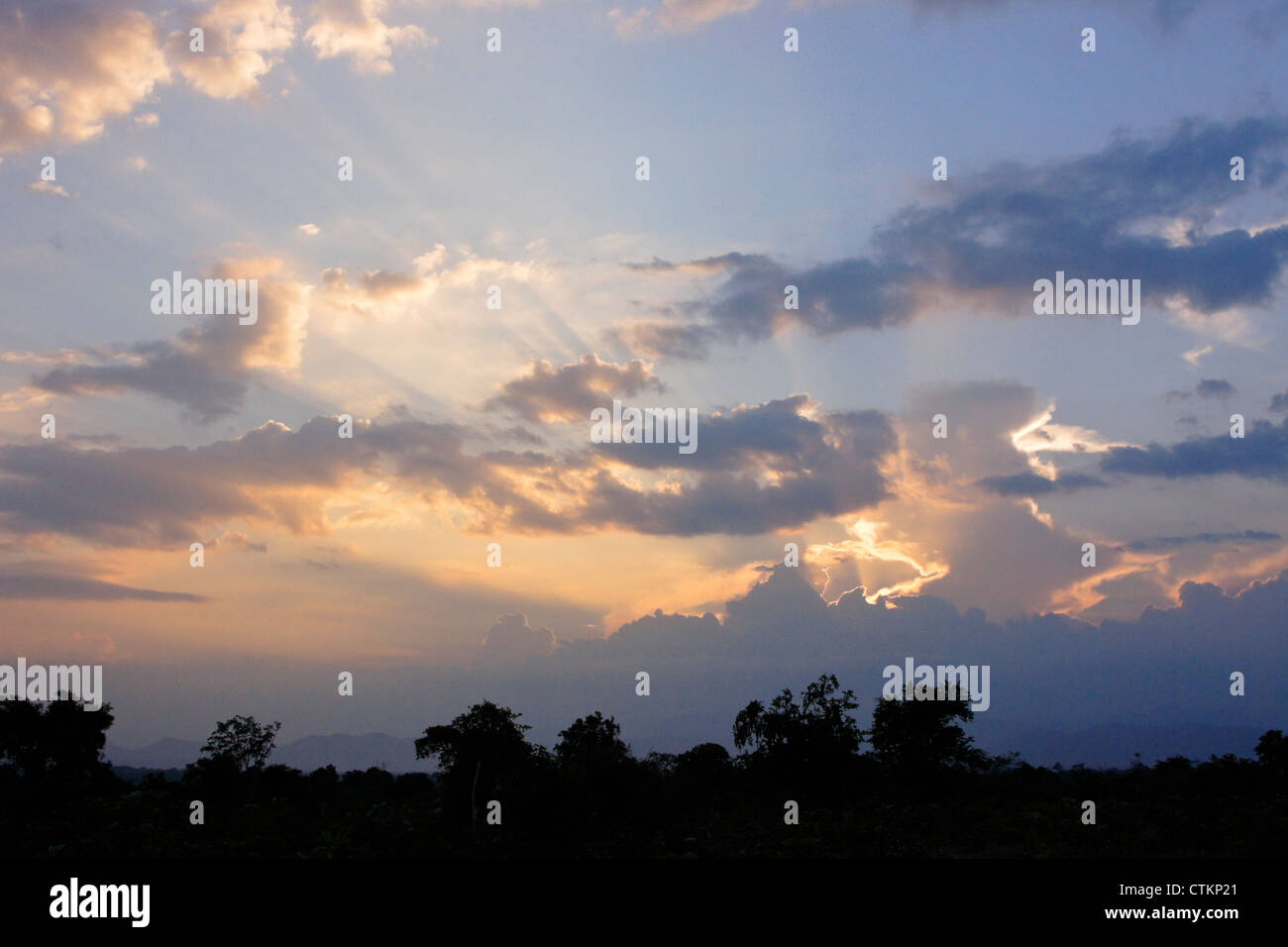 Sun dietro le nuvole (raggi crepuscolari) Foto Stock