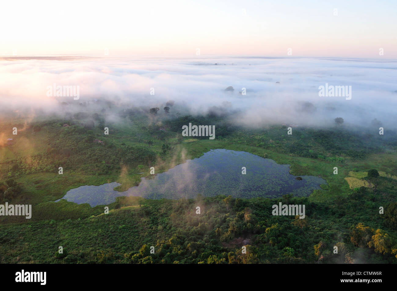 Early Morning mist oltre il lago naturale, vicino alla foresta Moribane, centrale del Mozambico Foto Stock