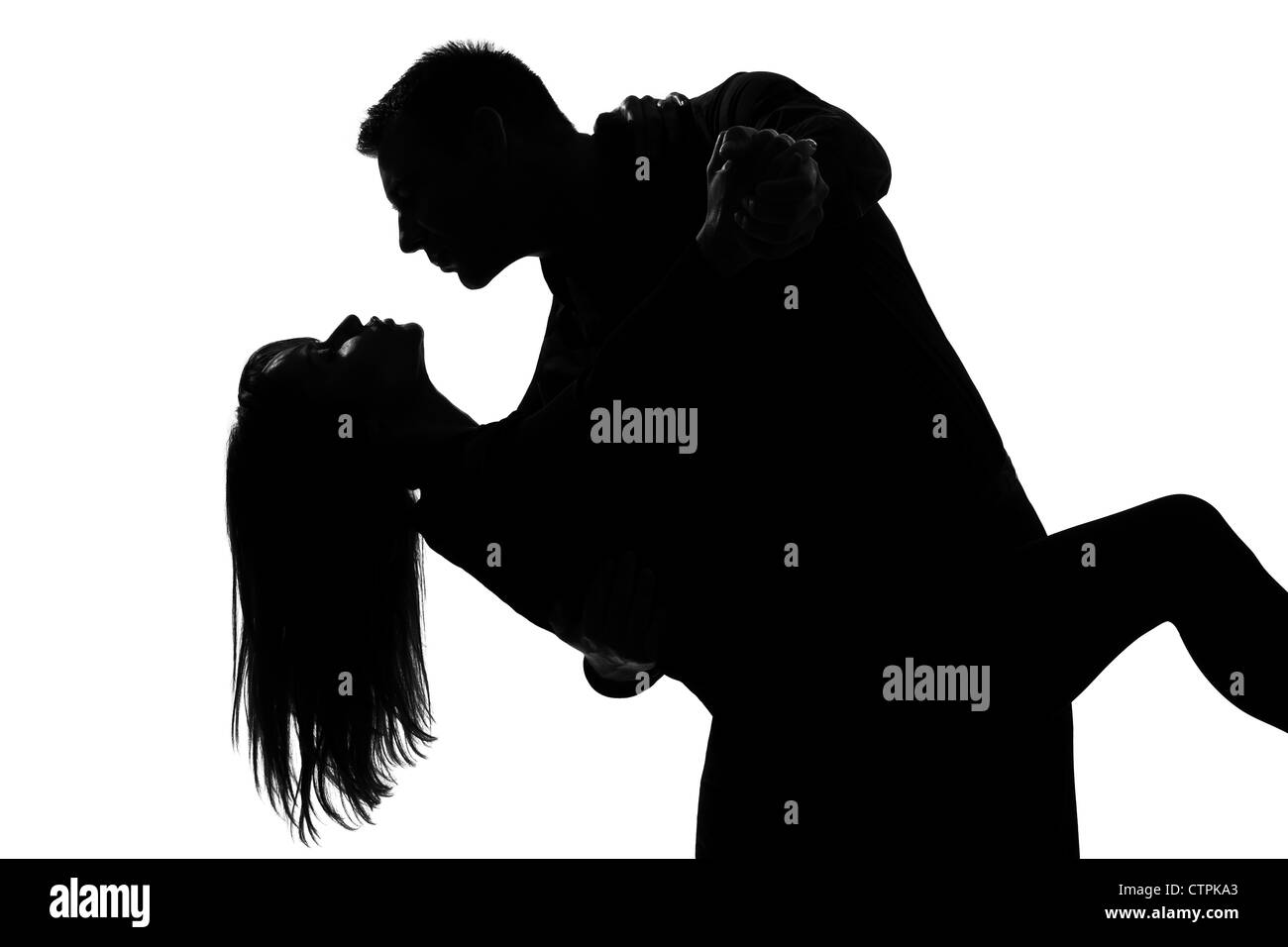 Una coppia caucasica amanti l uomo e la donna ballare il tango in studio silhouette isolati su sfondo bianco Foto Stock