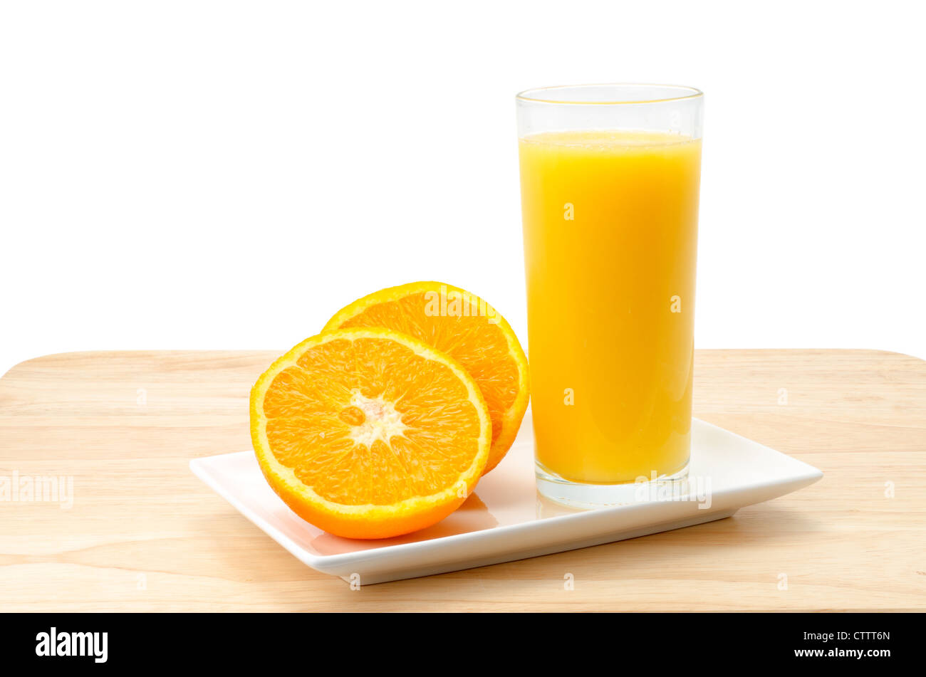 Spremuta di arancia fresca con un arancio che è stato tagliato a metà - studio shot con un semplice sfondo bianco Foto Stock