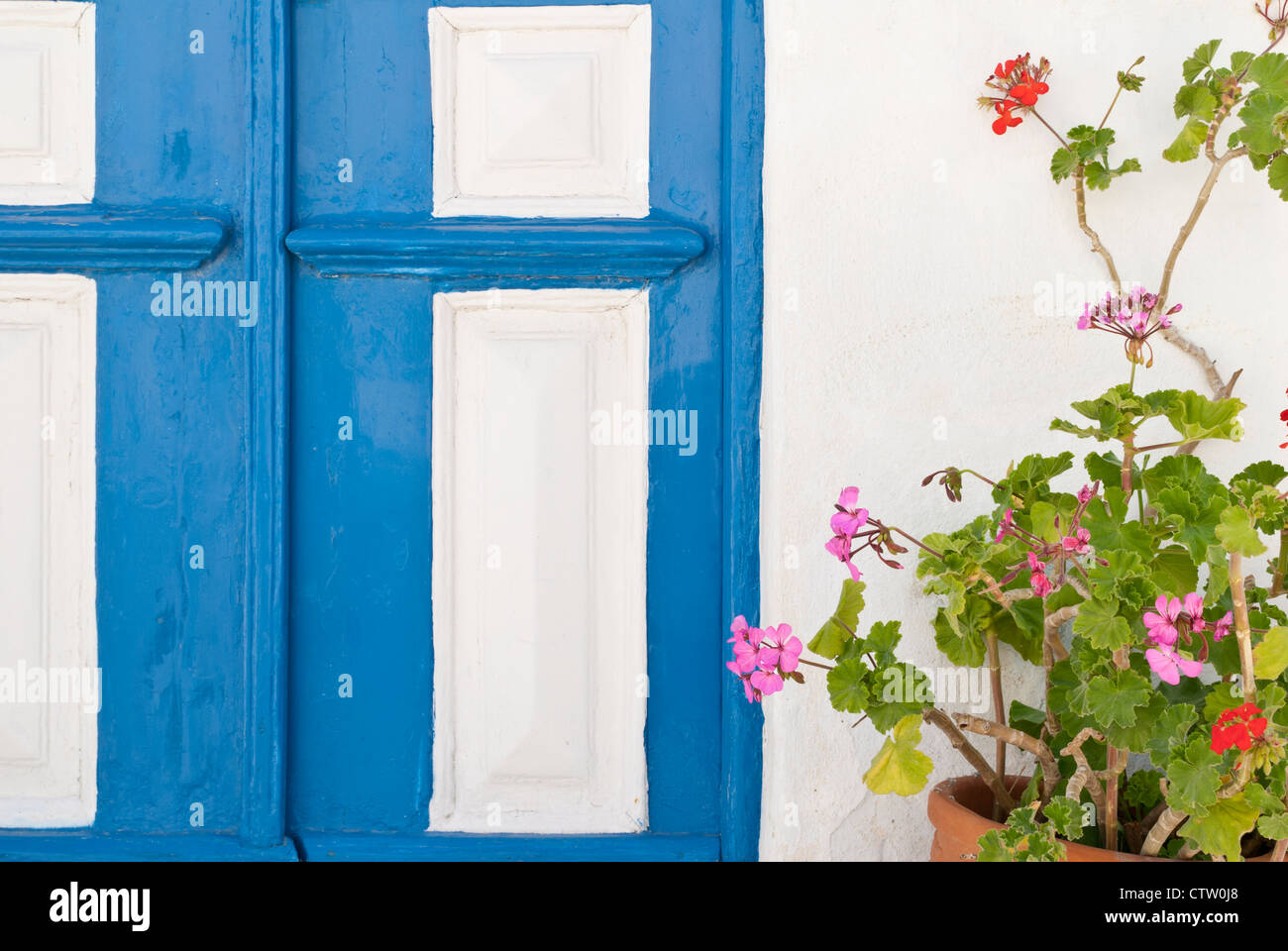 Isola greca di dettaglio di una porta blu e rosso geranio nel vecchio Hora di Serifos Island, Grecia Foto Stock