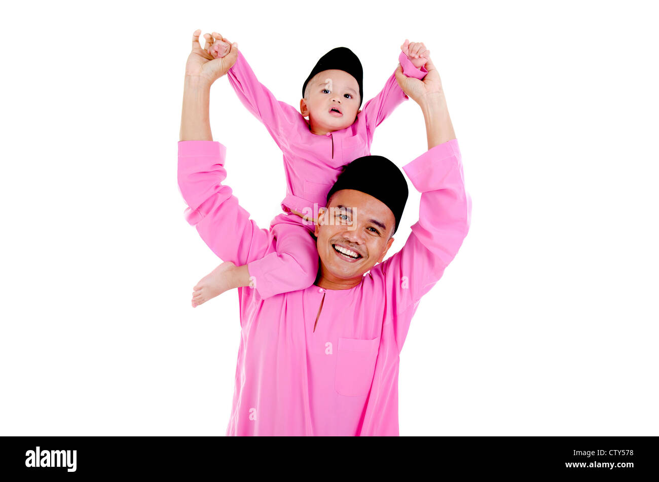 Felice malay padre e figlio, nel tradizionale baju melayu ,songkok abbigliamento Foto Stock