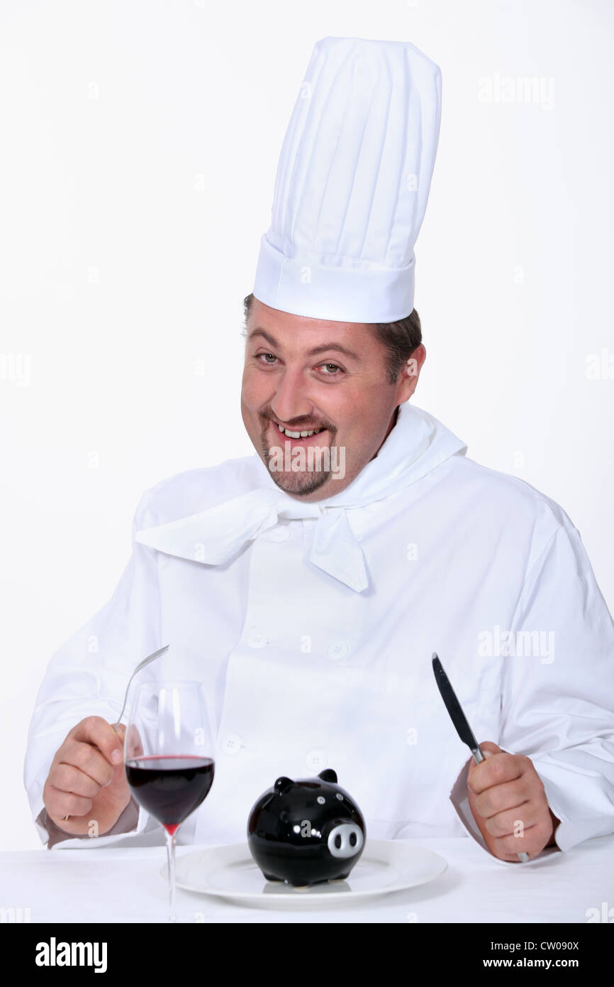 Chef di mangiare un salvadanaio Foto Stock