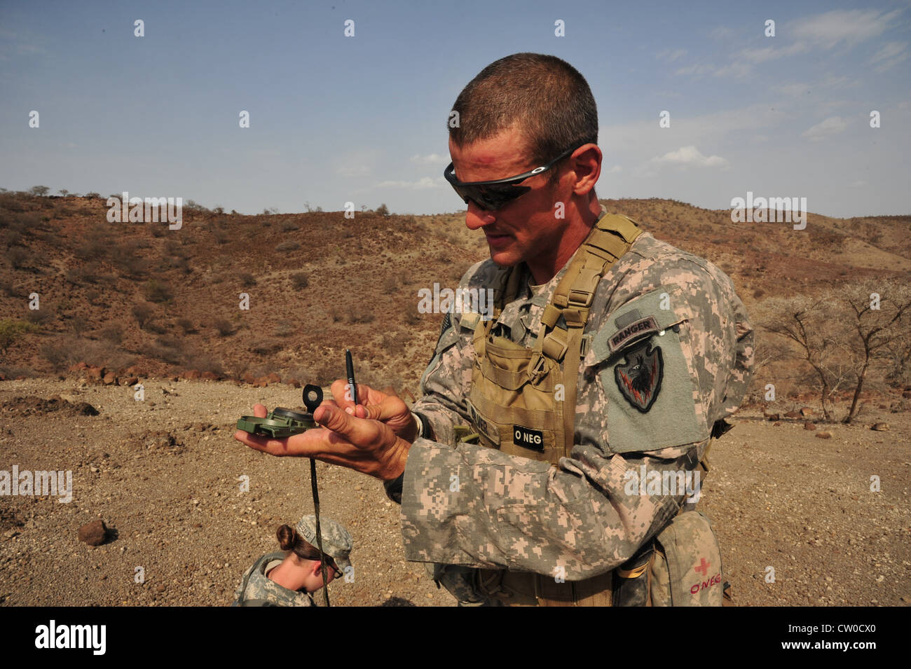 S. Esercito Sgt. Matthew Belver dal 3° Squadron, 124° Divisione Cavalleria, Task Force Raptor scrive le coordinate della bussola mentre partecipa alla corsa a sperone dell'unità il 2 agosto 2012, nei deserti di Gibuti. Il giro a sperone è una tradizione di cavalleria in cui un trouper deve superare una serie di test che valutano la competenza fisica, di leadership, tecnica e tattica in un ambiente ad alto stress per guadagnare i suoi speroni e diventare un membro dell'Ordine dello Spur. Task Force Raptor è schierato a sostegno della task force congiunta combinata - Corno d'Africa Foto Stock