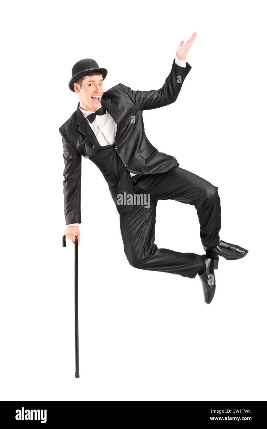 Il mago di salto e in possesso di una canna, isolati su sfondo bianco Foto Stock