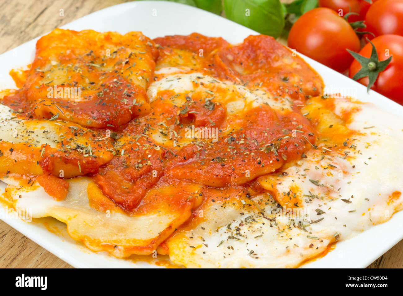 Ravioli di carne di manzo con un ricco di pomodoro e salsa di basilico e rabboccato con besciamella - profondità di campo - studio shot Foto Stock