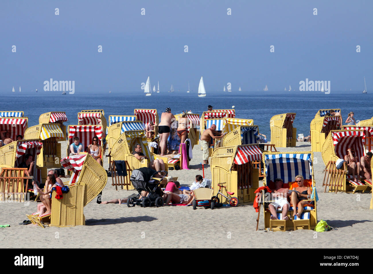 I bagnanti in sedie a sdraio sul soleggiato Mar Baltico spiaggia , Germania, Schleswig-Holstein, Travemuende, Lubecca Foto Stock