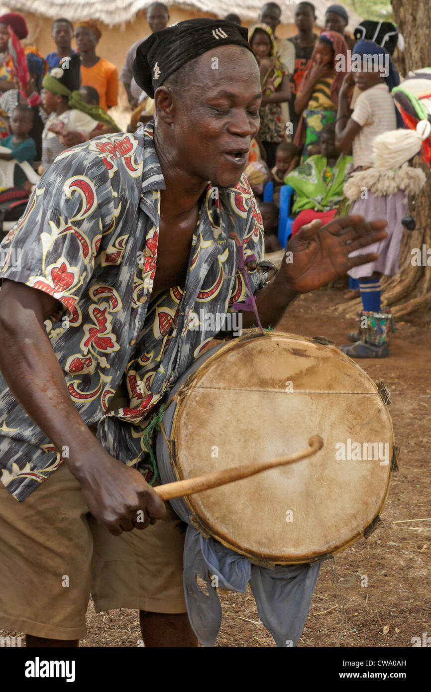 Dagomba uomo battendo il tamburo gungon, Wovogumah village, Ghana Foto Stock
