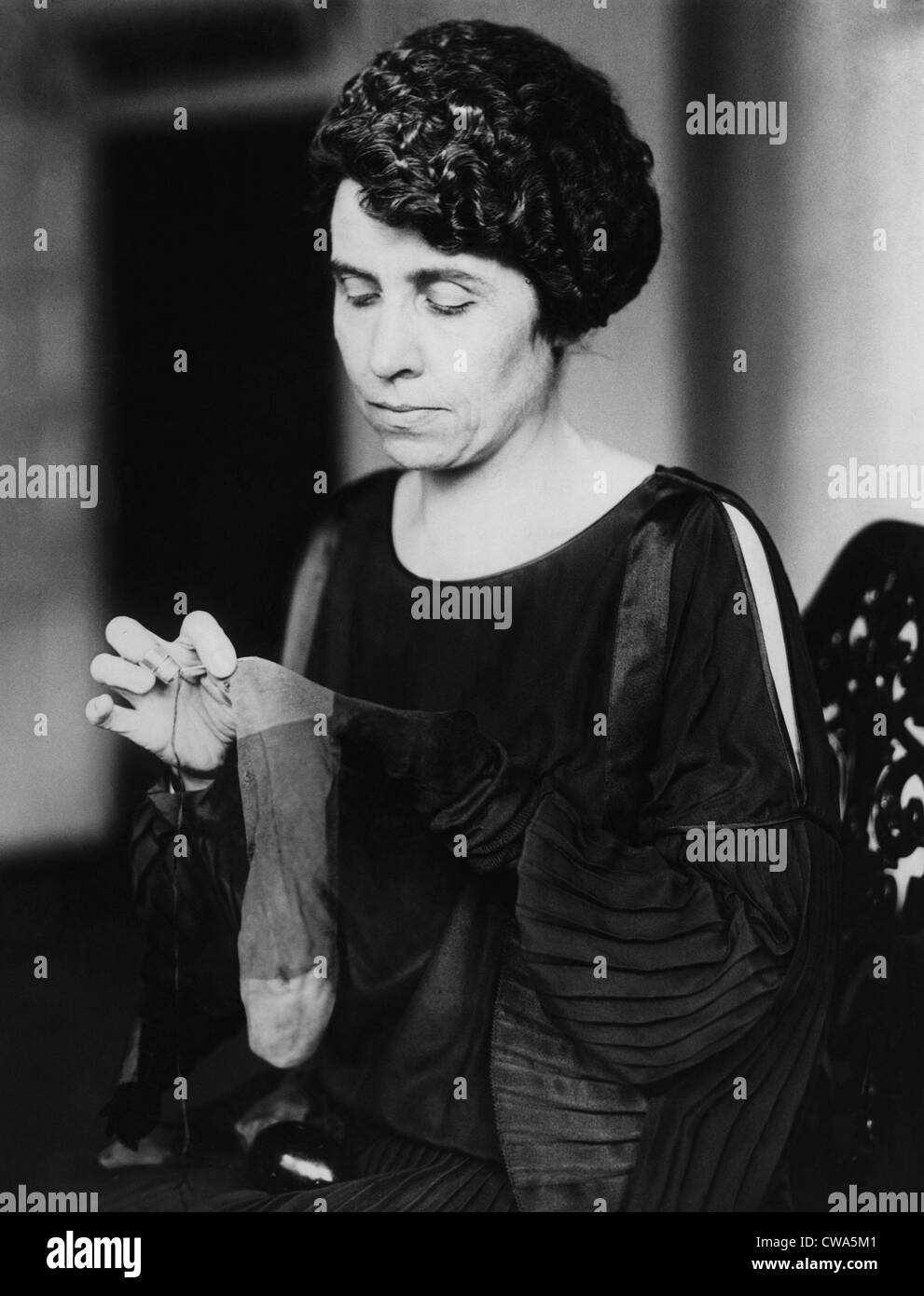 La First Lady grazia Coolidge maglieria i calzini del marito, 1923. La cortesia: Archivi CSU/Everett Collection Foto Stock