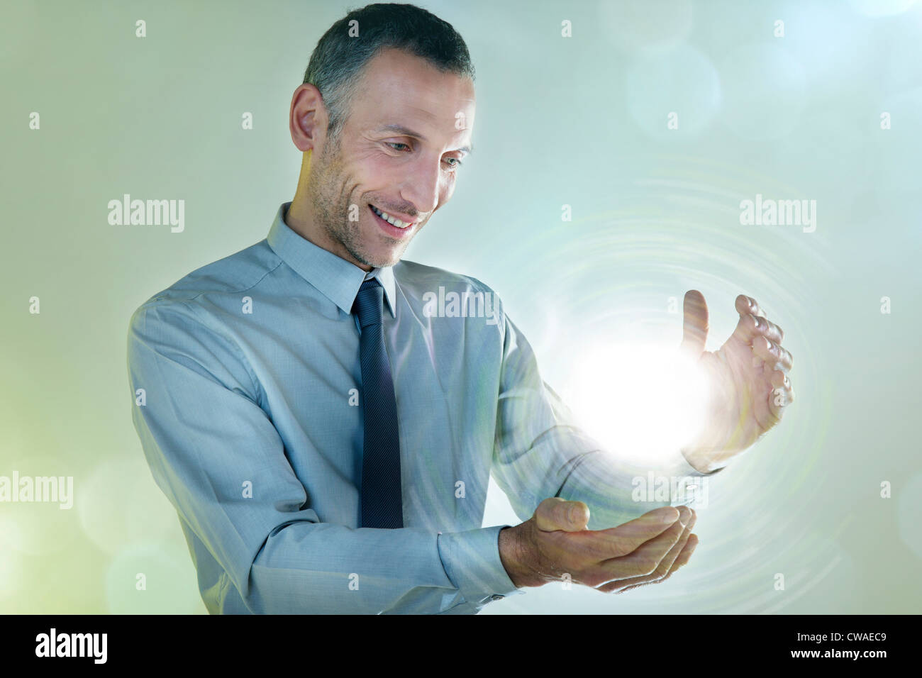 Imprenditore tenendo palla di luce Foto Stock