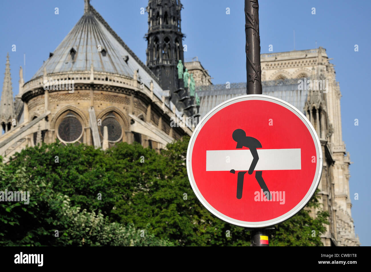 Parigi, Francia. Nessun segno di entrata dalla cattedrale di Notre Dame - " migliorati " da Clet Abraham - uomo che porta via la barra bianca Foto Stock