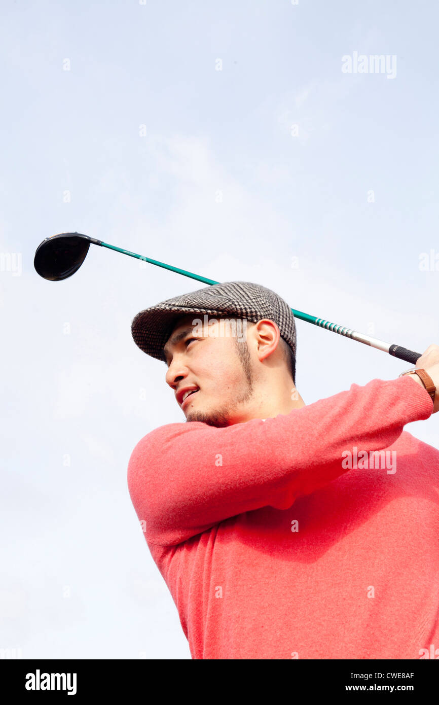 Ritratto di golfista Swinging Foto Stock
