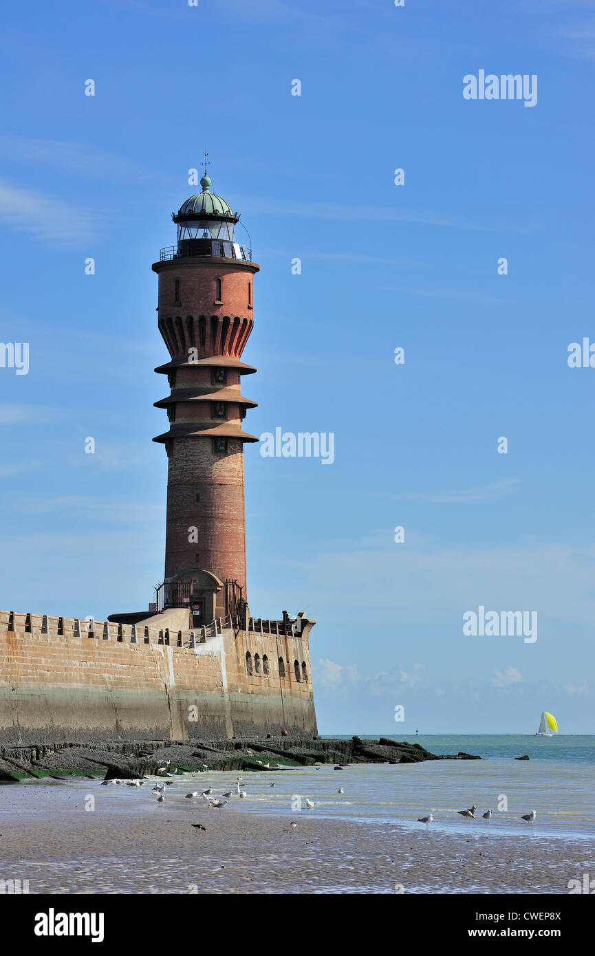 Il Faro de Feu Saint-Pol e barca a vela sul mare del Nord a Dunkerque / Dunkerque, Nord-Pas-de-Calais, Francia Foto Stock