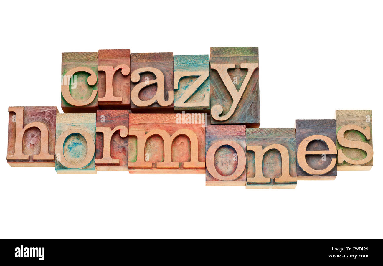 Crazy ormoni - parole isolate in rilievografia vintage tipo di legno colorati da inchiostri a colori Foto Stock