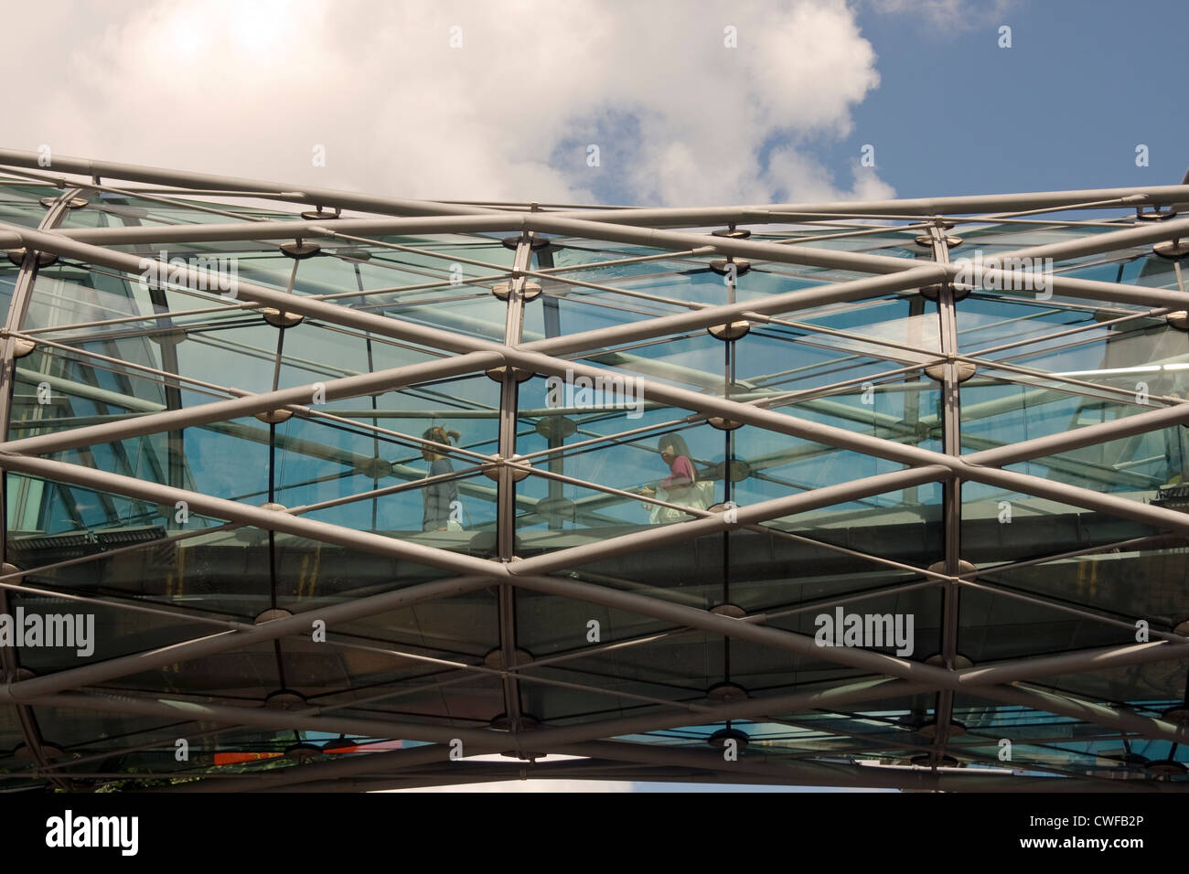 Shoppers croce dall'Arndale in Manchester di marchi e spencers attraverso il tunnel di overhead. Manchester. Foto Stock