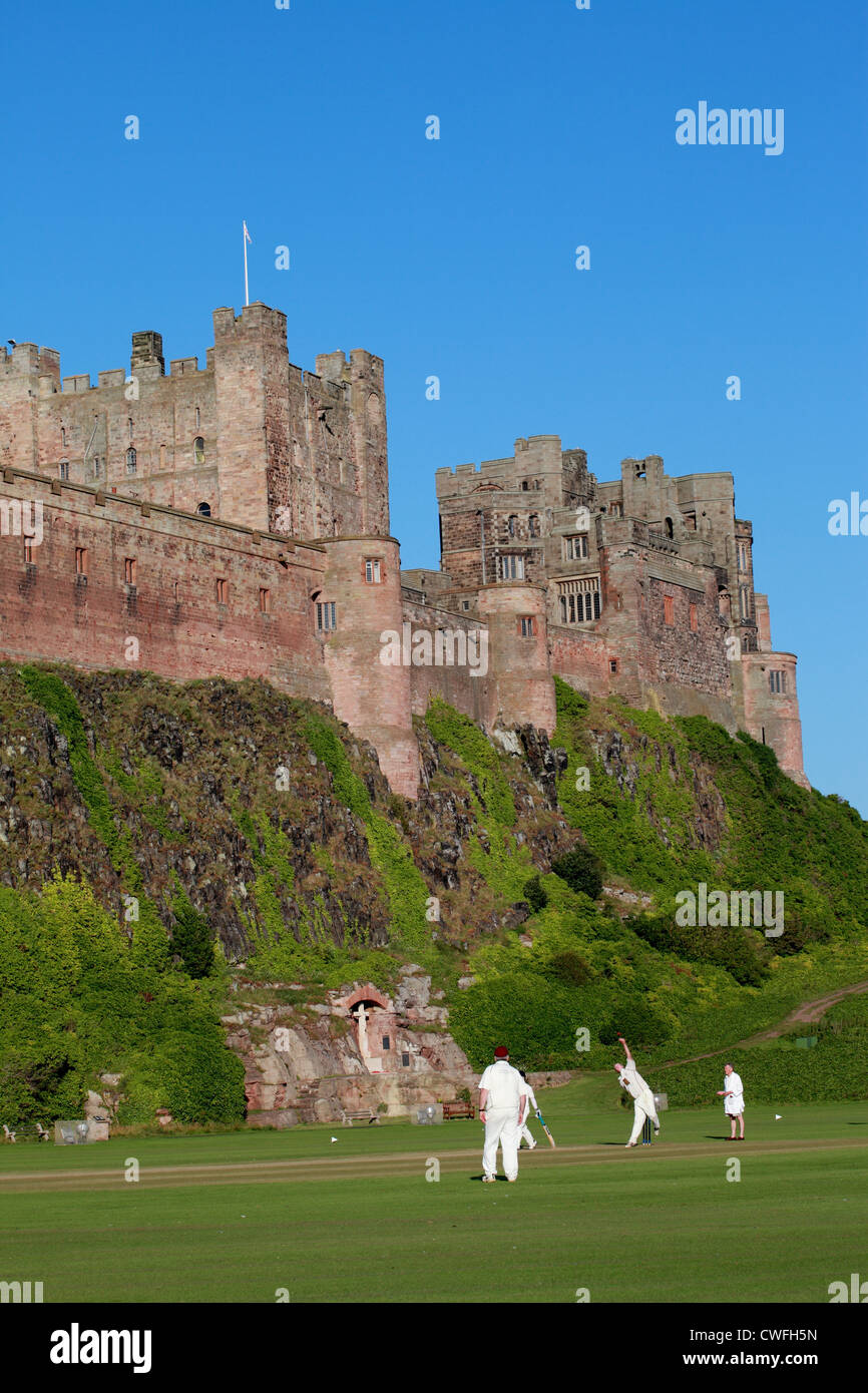 Partita di cricket che avvengono sul terreno sottostante il castello di Bamburgh Northumberland, Regno Unito Foto Stock