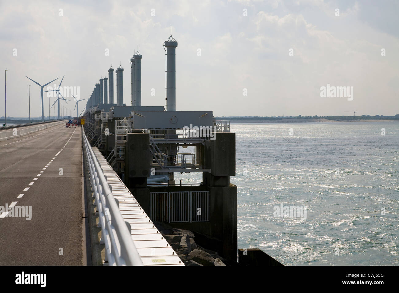 Le turbine eoliche e diga attraverso l'oceano Foto Stock