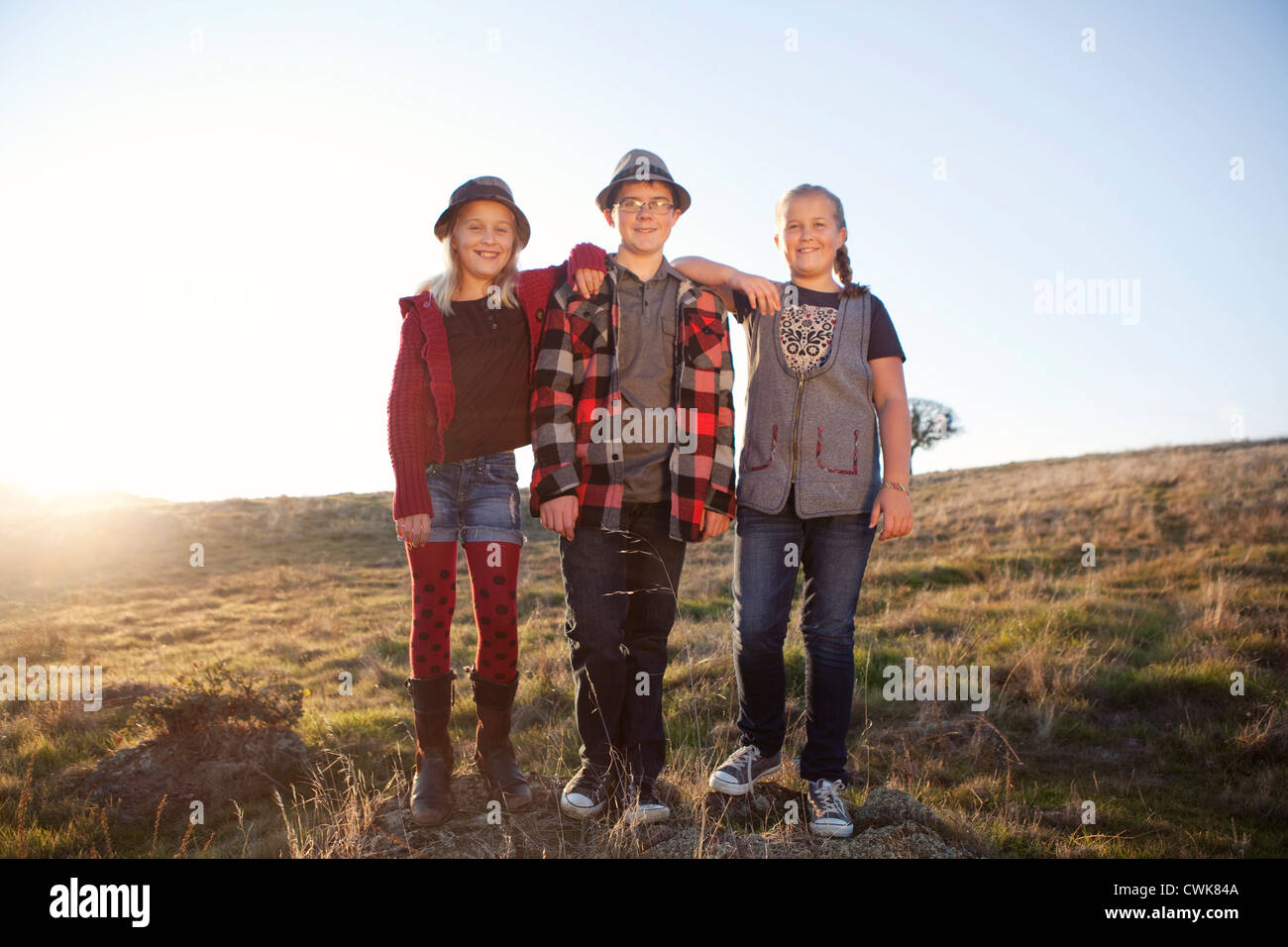Bambini caucasici in piedi in campo Foto Stock