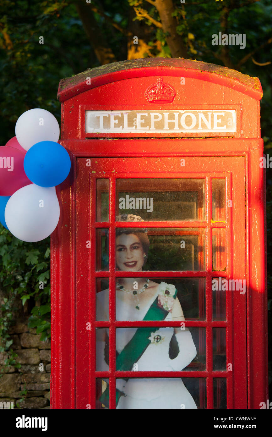 Immagine ritagliata della Regina Elisabetta II di controllo phonebox all street party per celebrare il Giubileo di diamante in Swinbrook, il Costwolds, REGNO UNITO Foto Stock