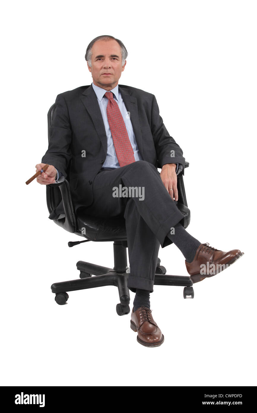 Imprenditore seduto in una sedia girevole Foto Stock