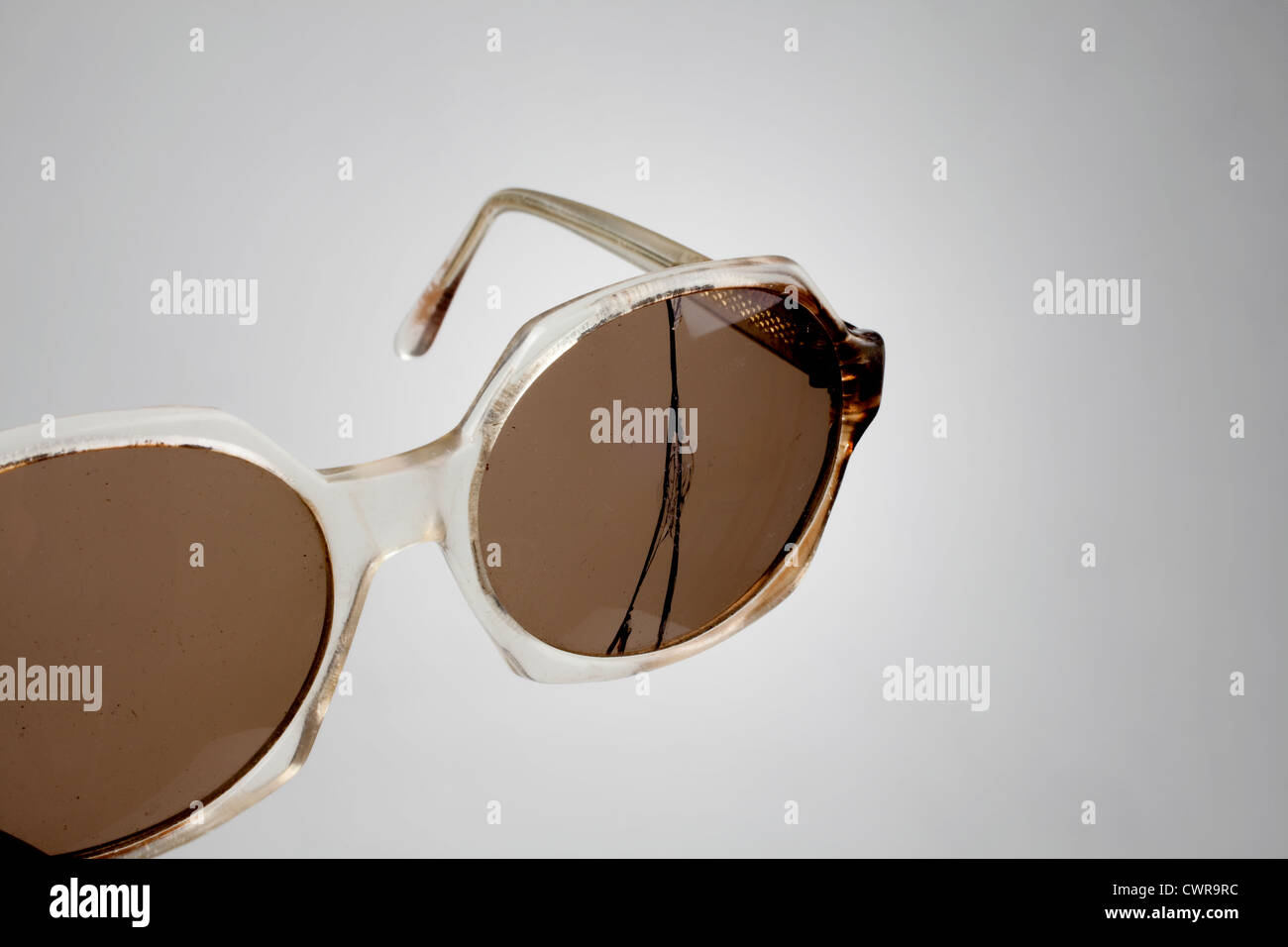 Una vecchia tromba cerchiati di occhiali con una lente incrinato Foto Stock