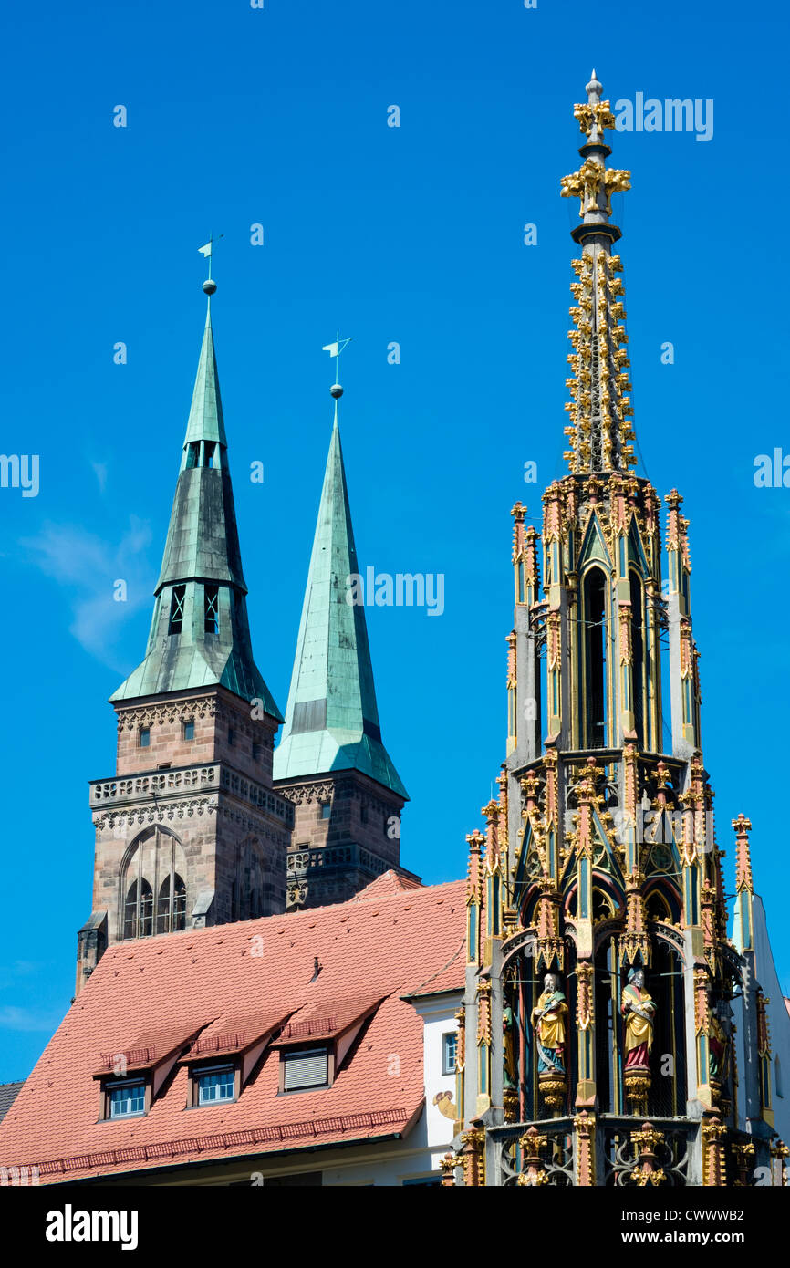 Schoene Brunnen (Bella Fontana) e le guglie di St Sebald la chiesa a Norimberga in Baviera Germania Foto Stock
