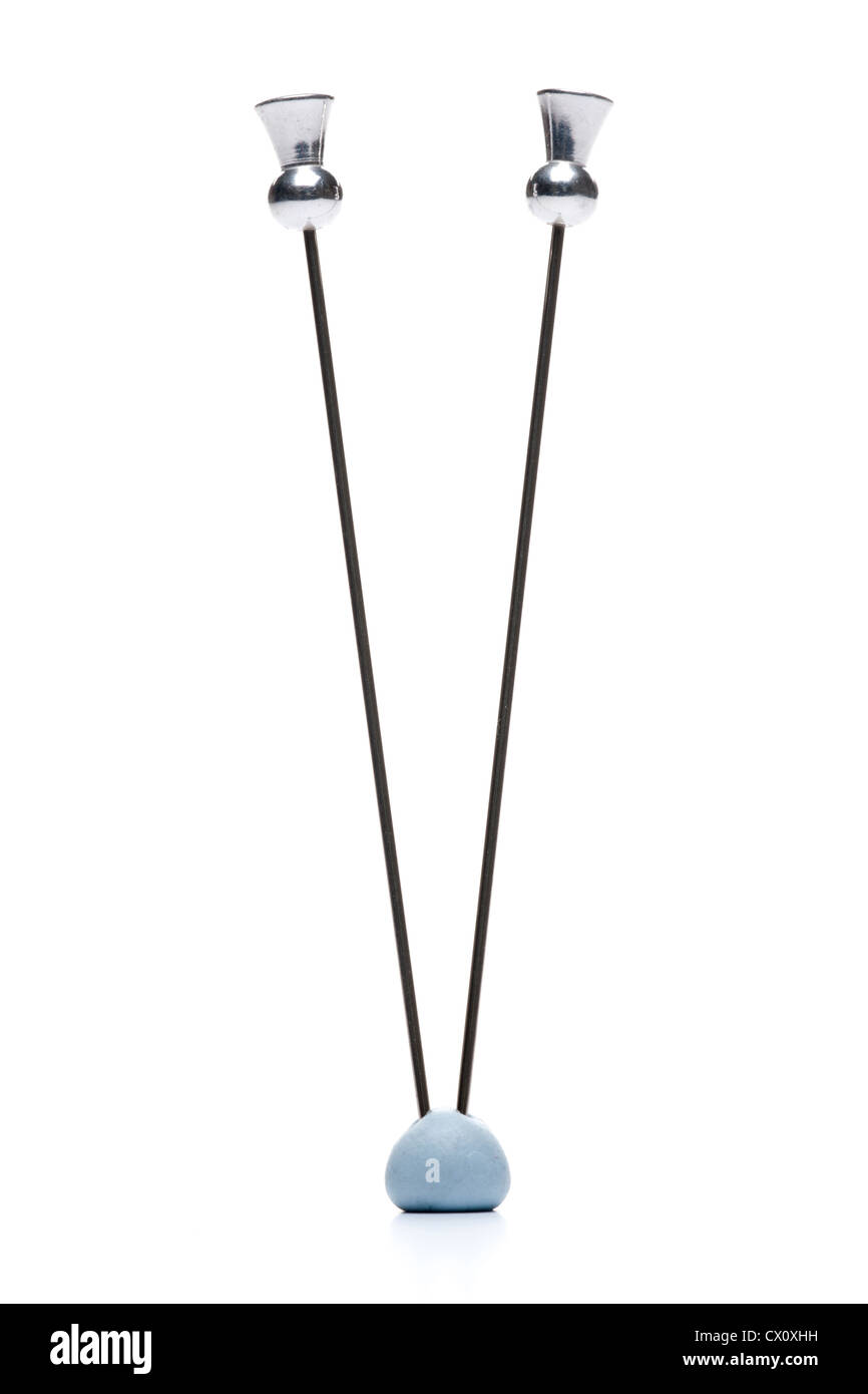 Due hatpins metallico inceppato in blu tack Foto Stock