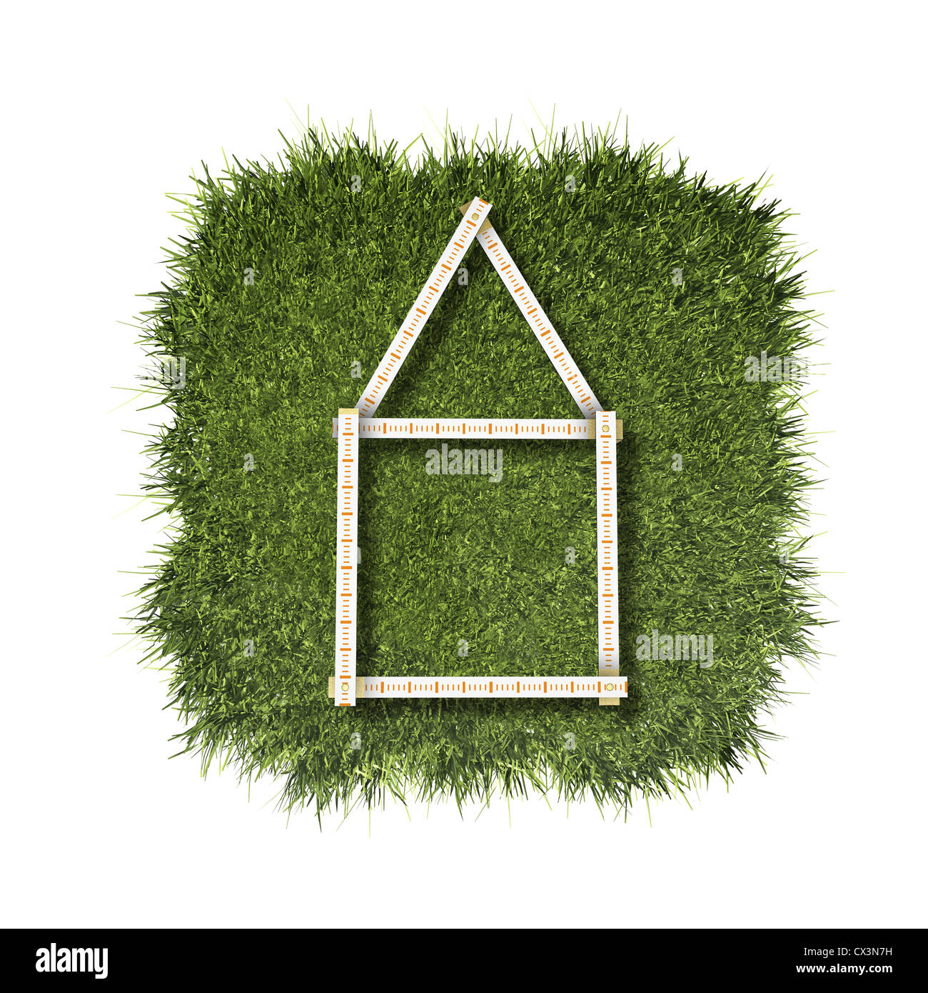 Regola pieghevole, casa sul prato verde - Zollstock, Haus aus grünem Gras auf weissem Hintergrund - Foto Stock