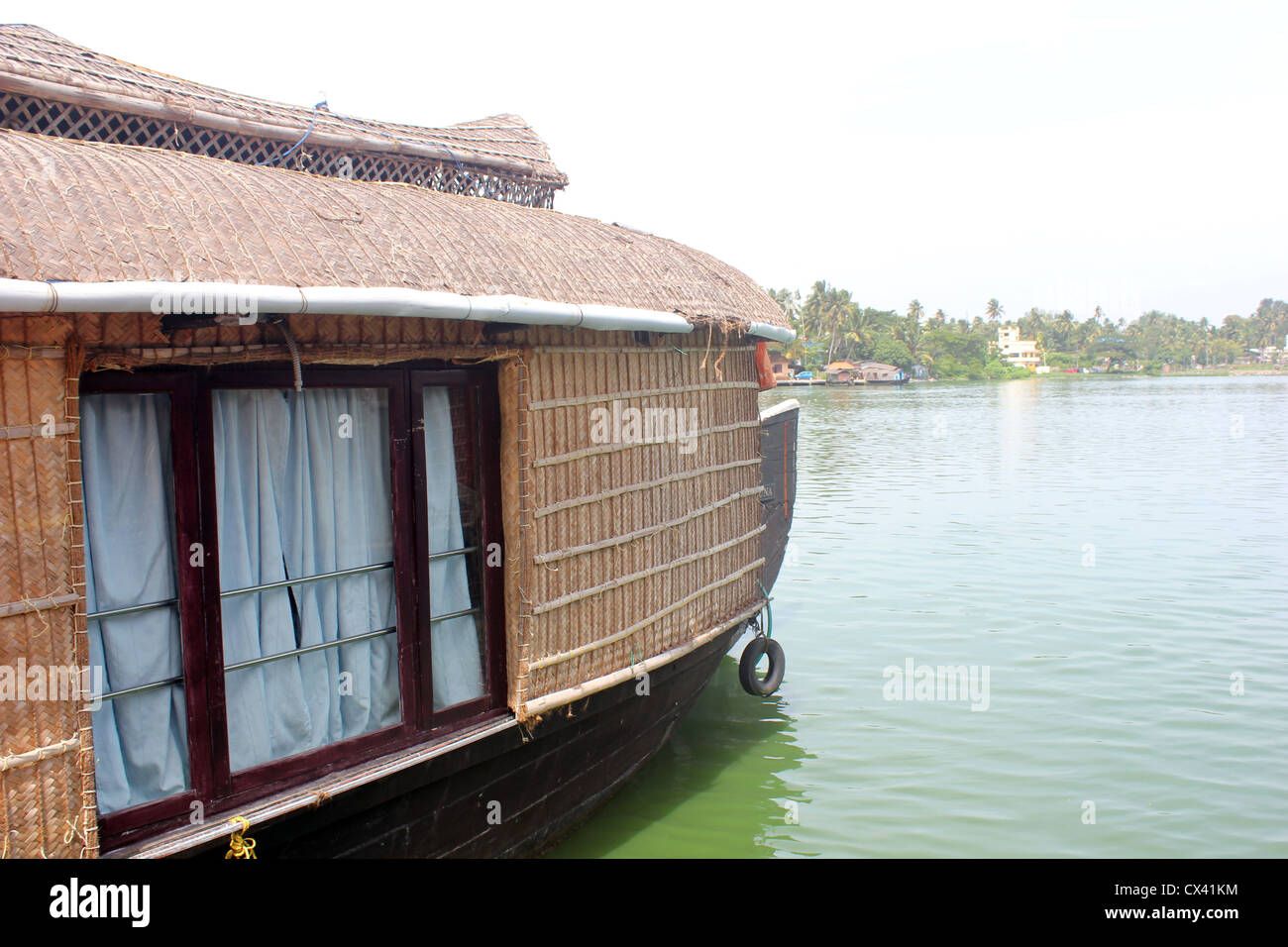 Una vista del lago Astamudi con una casa galleggiante vela. Foto Stock