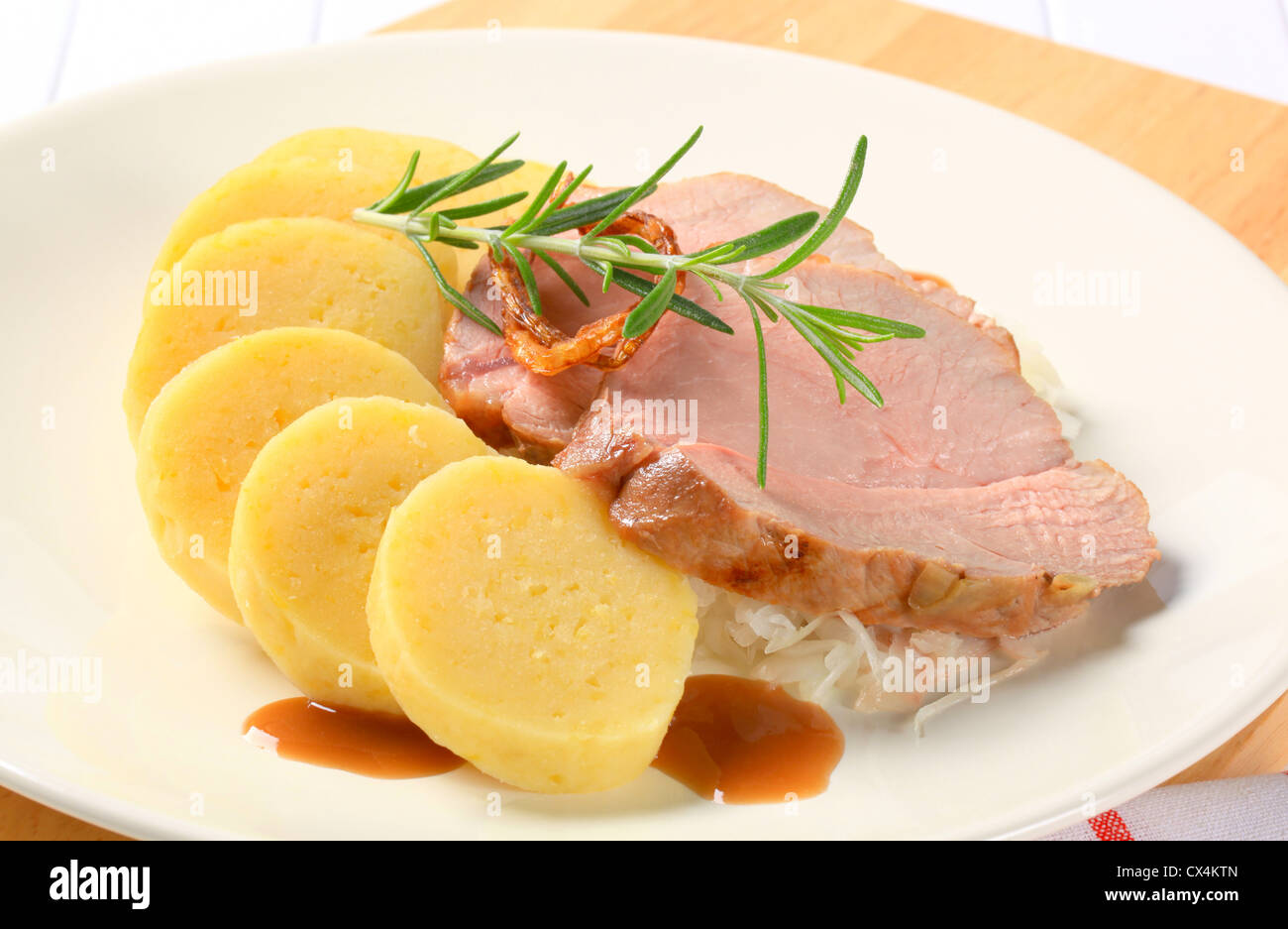 Piatto di carne di maiale con gnocchi di patate e cavolo bianco Foto Stock