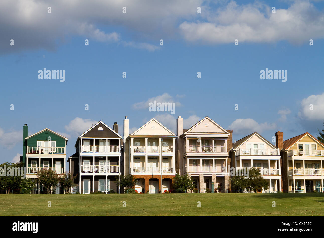 Townhomes esclusivo per i ricchi costruito su una collina di erba in una fila contro un nuvoloso cielo blu a Memphis, Tennessee. Foto Stock