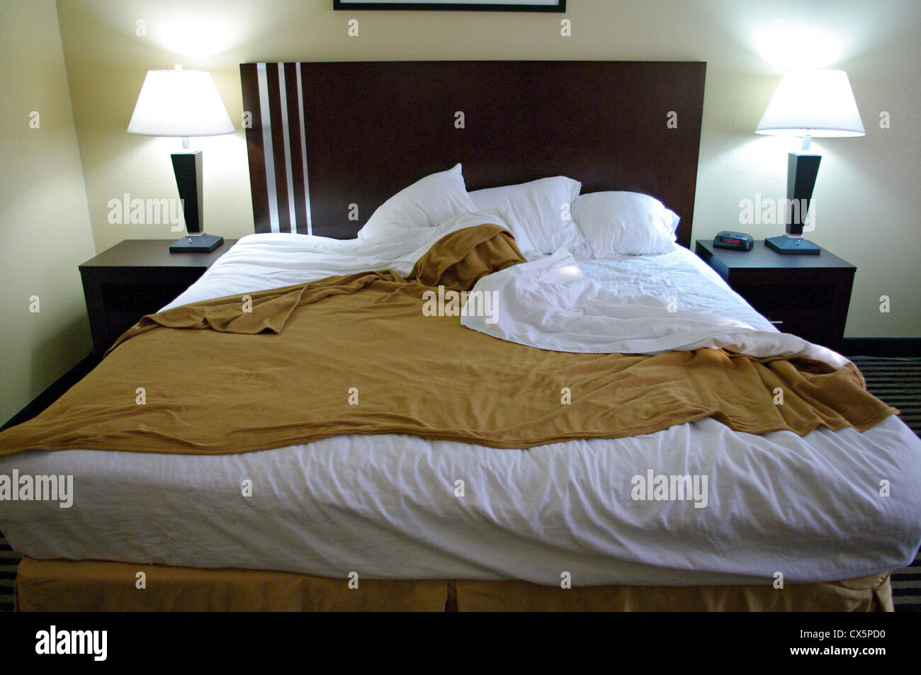 Un letto disfatto in una stanza Foto Stock