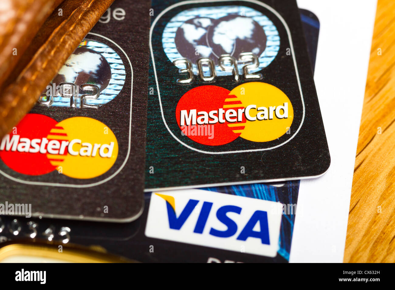 Dublino, Irlanda - 12 settembre 2012. Si tratta di un studio shot di 2 schede master e una Visa Debit Card su una scrivania in legno. Foto Stock