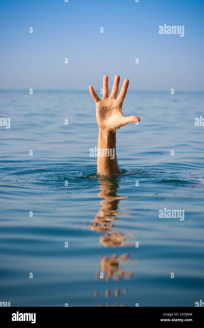 Unica mano di annegamento di uomo in mare per chiedere aiuto Foto Stock