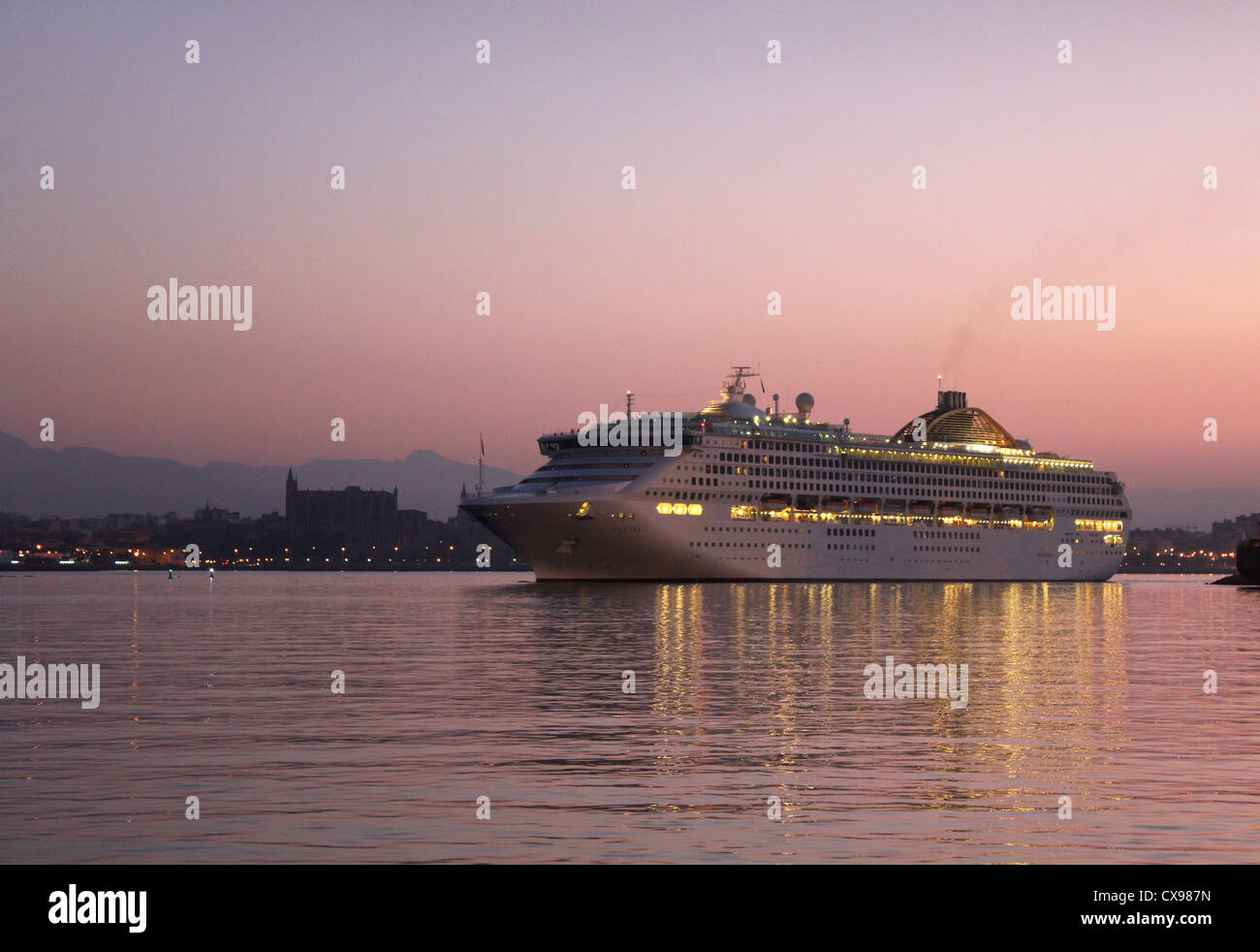 P & O Cruises nave da crociera "Oceana' - entrando in porto alla mattina presto / pre-sunrise con la storica cattedrale di Palma avanti - Palma. Foto Stock