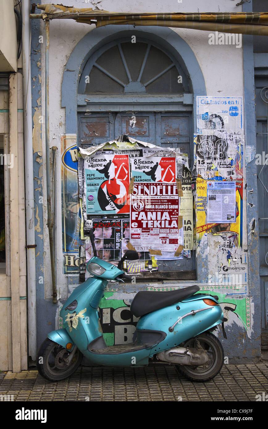 Spagna. Scooter parcheggiato di fianco al poster edificio coperto. Foto Stock