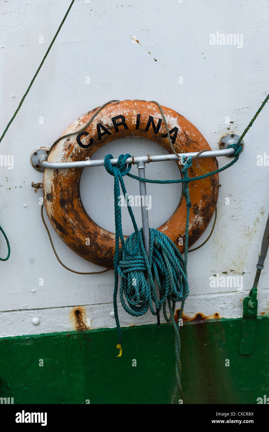 Salvagente su una vecchia barca da pesca nella città di Dingle Harbour, Repubblica di Irlanda. Foto Stock