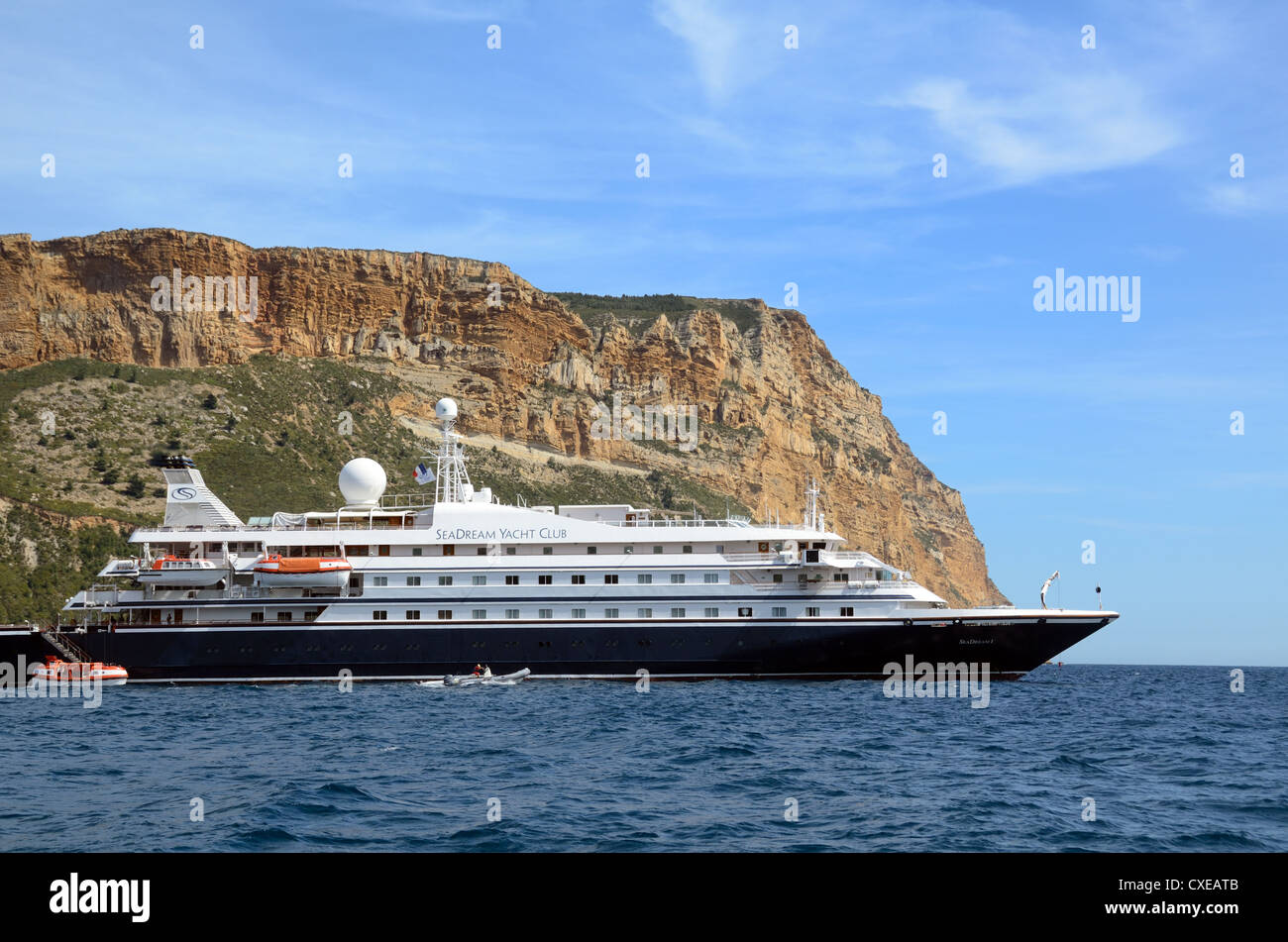 Cap Canaille Cliffs & Yacht di lusso, Cruiser o nave da crociera ancorata nella baia di Cassis Mediterraneo Provenza Francia Foto Stock