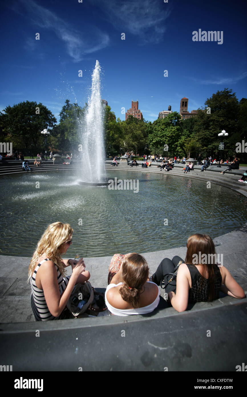Ragazze seduto presso la fontana a Washington Square Park di new york city Foto Stock
