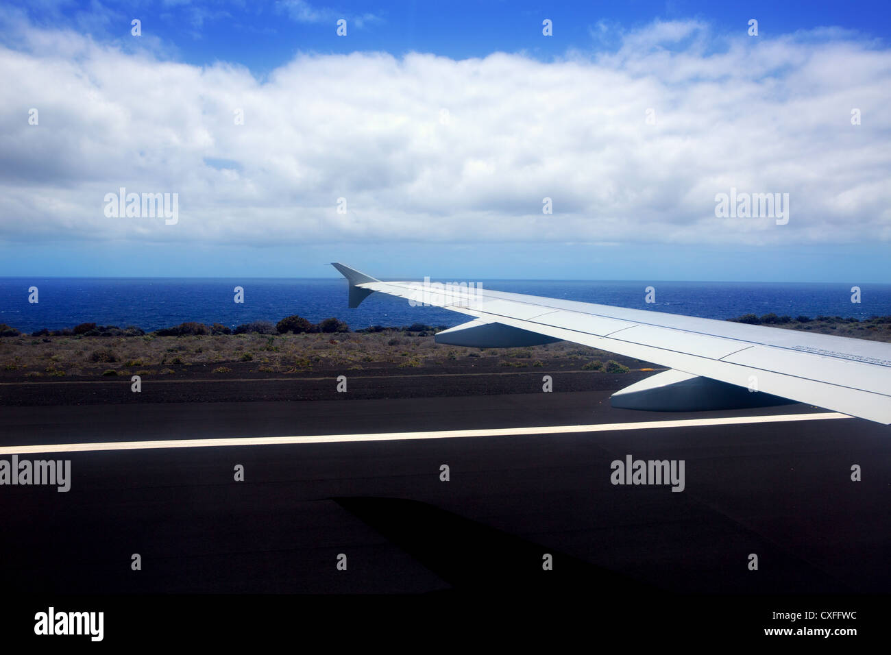 Atterraggio aereo nelle isole Canarie con nero suolo vulcanico e oceano Atlantico Foto Stock