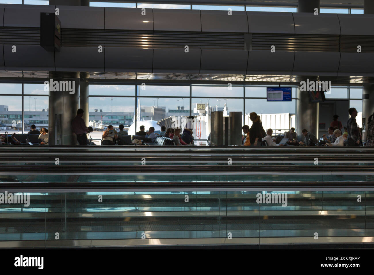 La gente in attesa del loro volo a un cancello in Denver Airport Terminal Foto Stock
