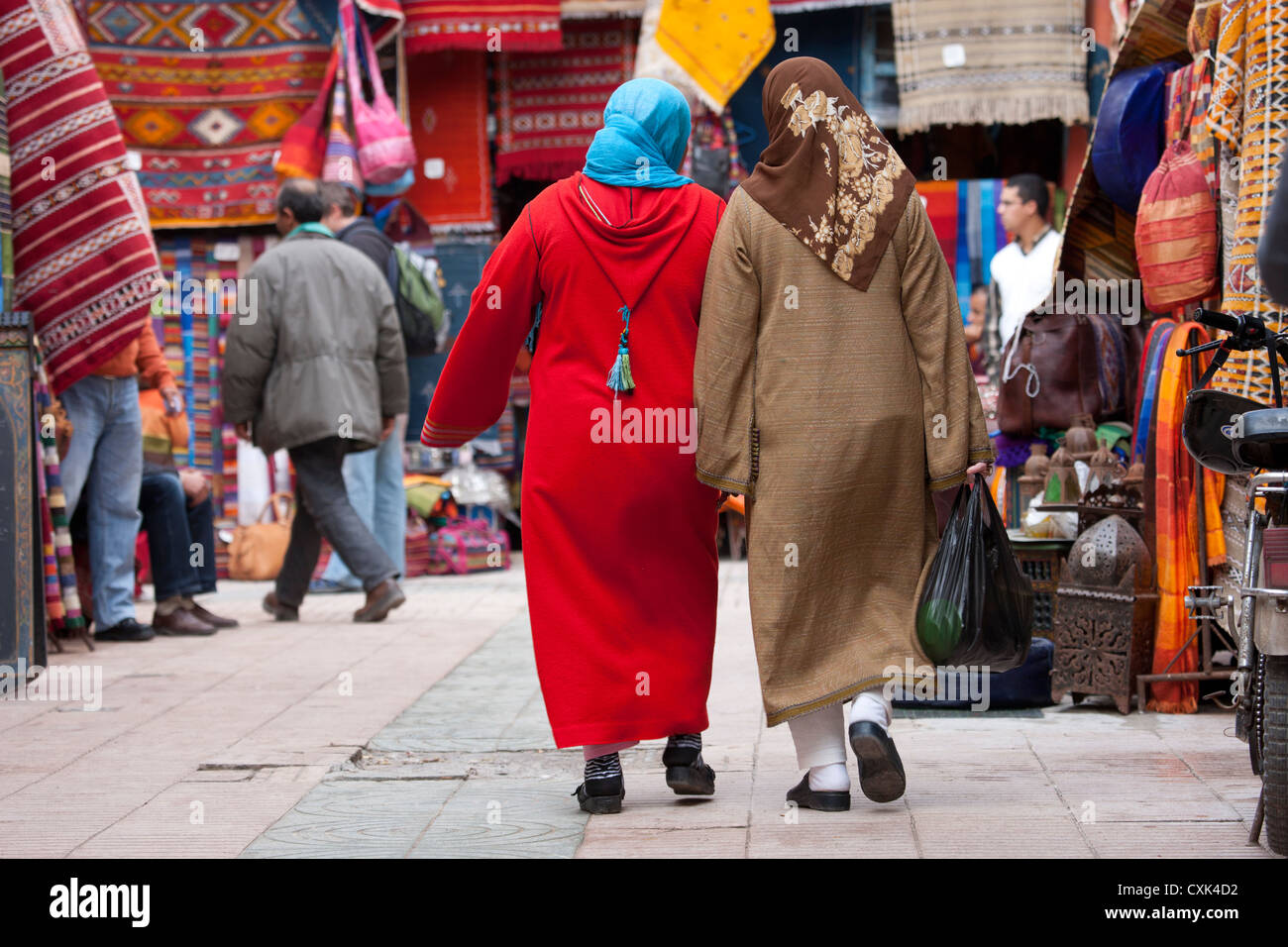 Donne locali in djellabas camminando nel mercato, Essaouira, Marocco Foto Stock