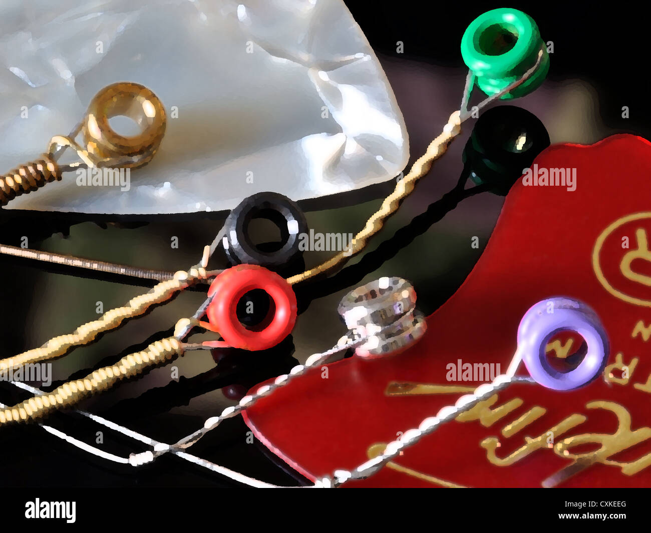 Acustica bronzo rame avvolte le corde di una chitarra con perline colorate per spine a ponte Foto Stock