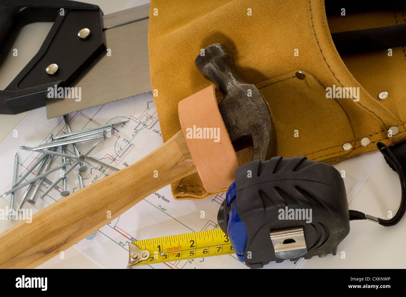 Materiali di consumo di un lavoratore edile o un uomo pratico, compreso un martello, un nastro di misurazione, chiodi, Cintura portautensili e stampe blu o piani Foto Stock