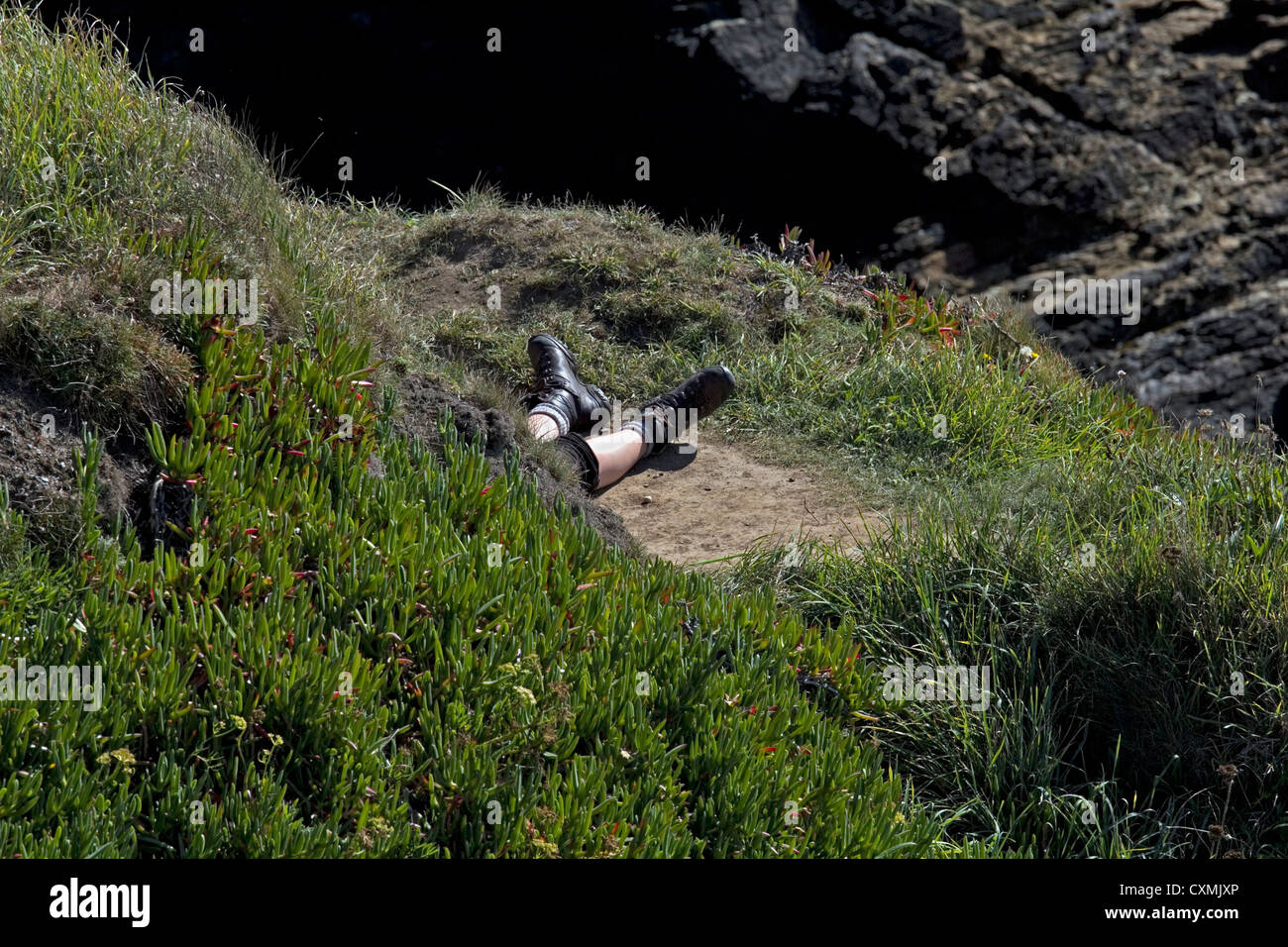 Un rambler di gambe pallido e stivali al sole in lucertola, Cornwall, Inghilterra Foto Stock